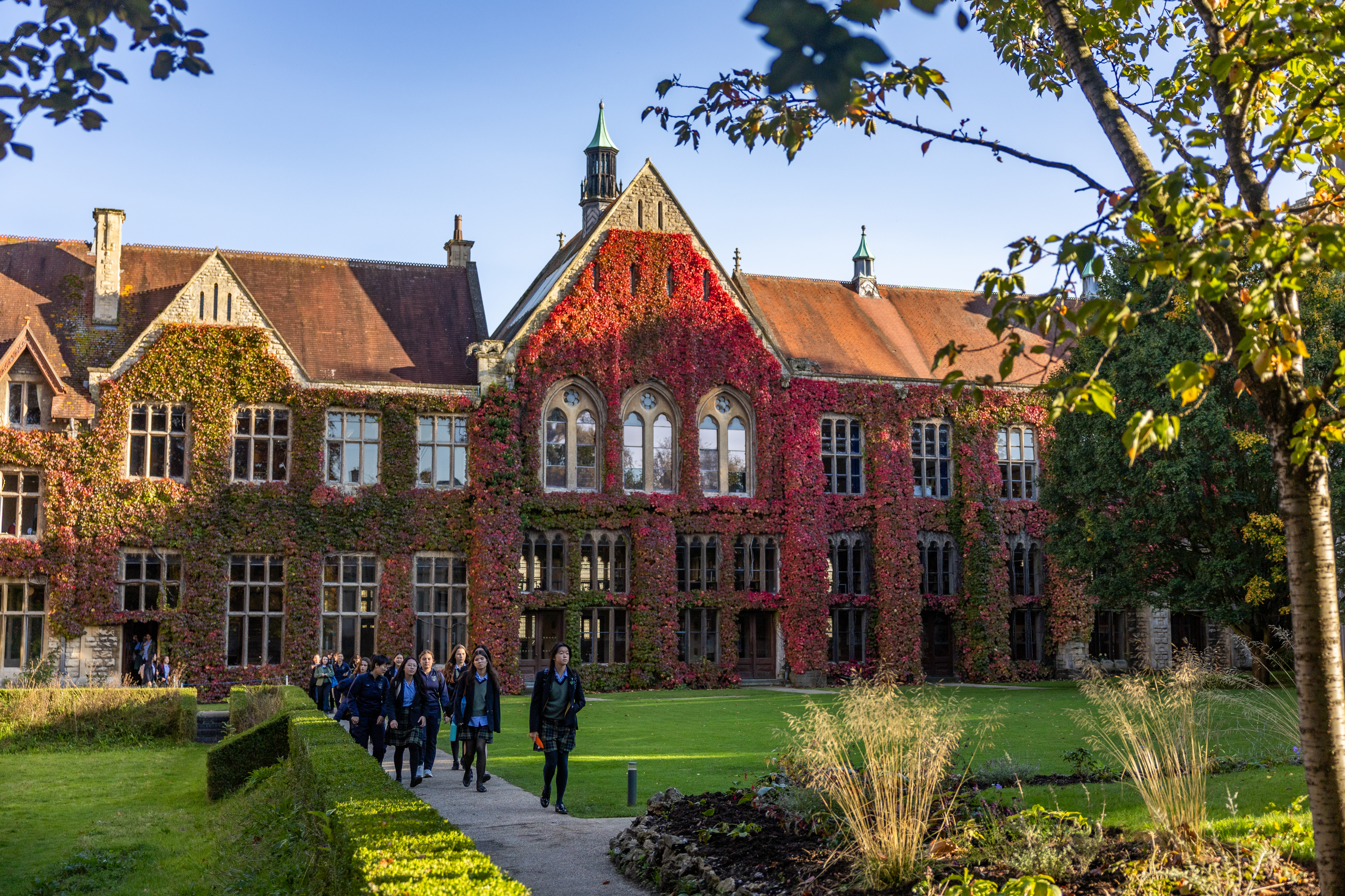 Students walking along the grounds in front of the main Cheltenham Ladies’ College building